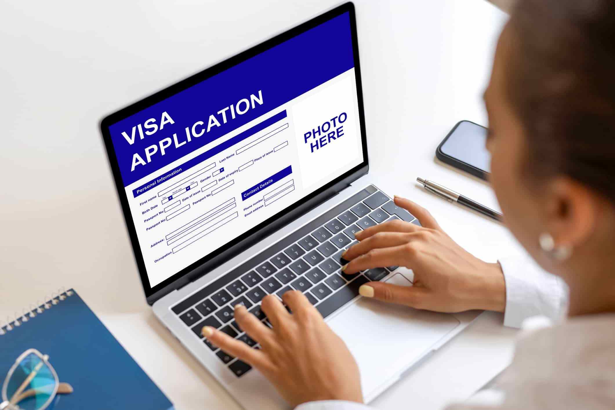 A blank visa application form titled "VISA APPLICATION" with sections to be filled out for personal information, a photo, and contact details.