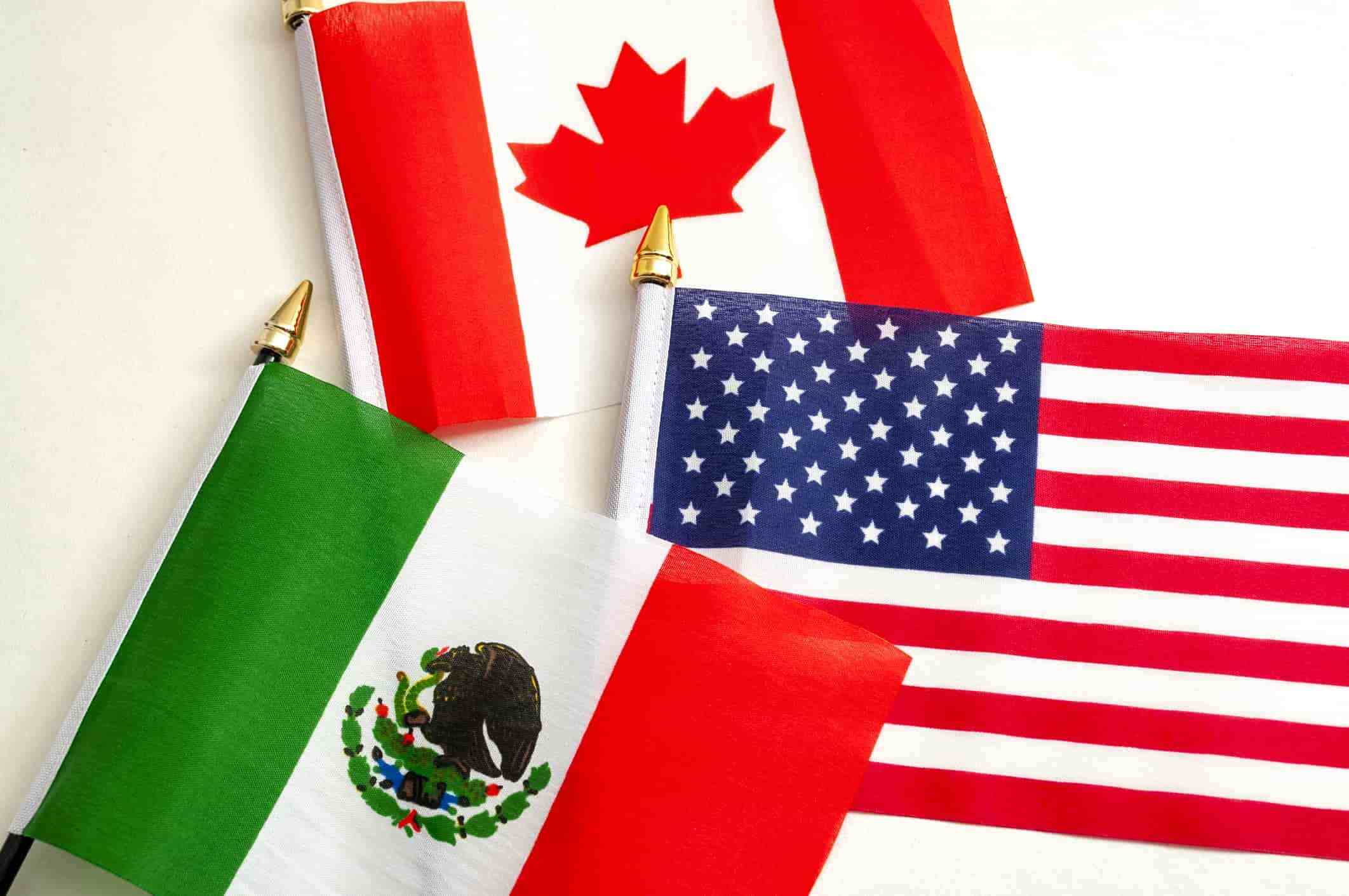 Flags of Canada, the United States, and Mexico, representing the three countries hosting the event FIFA World Cup 2026