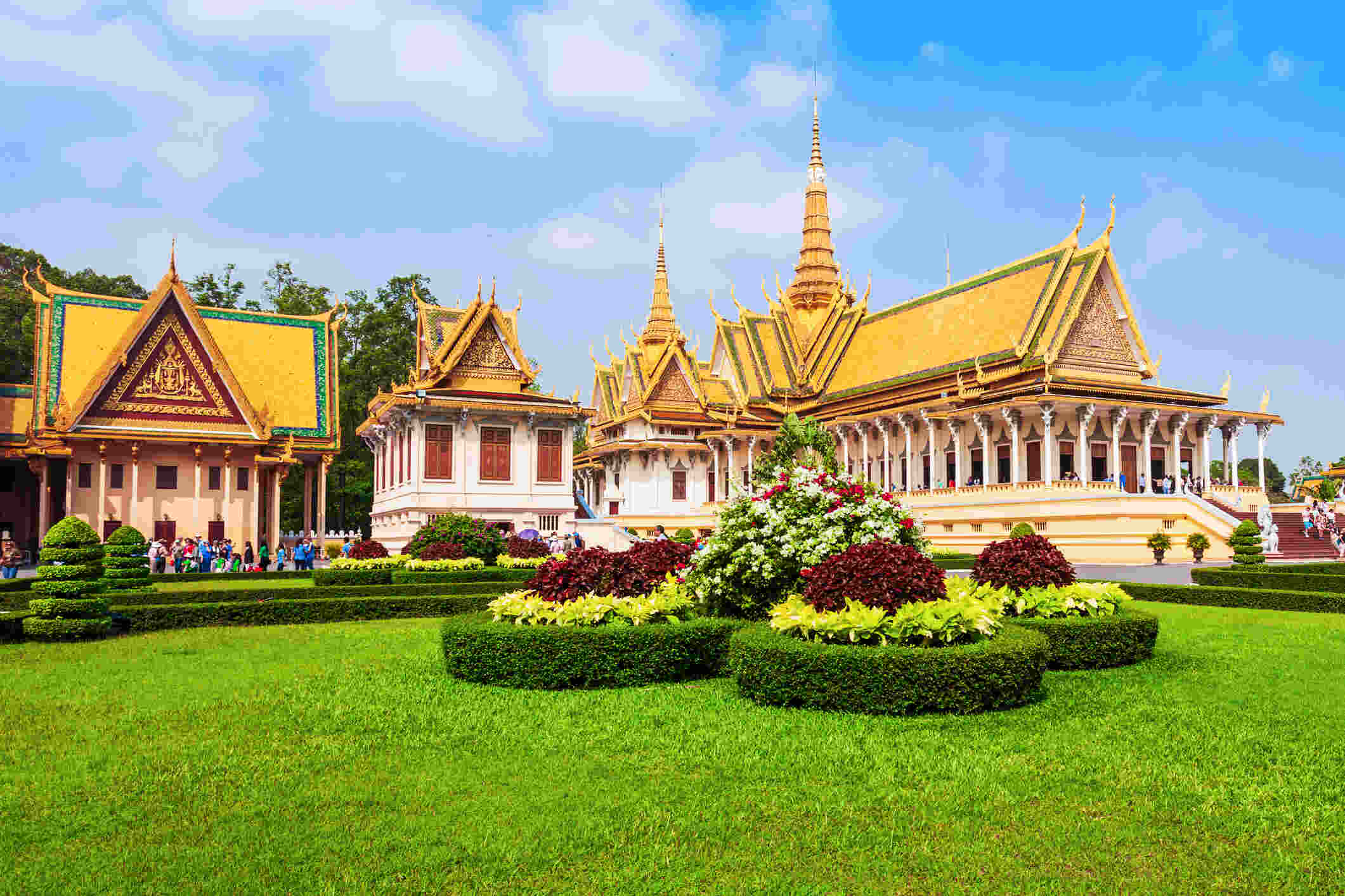 The Royal Palace in Phnom Penh, Cambodia, with ornate golden buildings and lush green gardens.